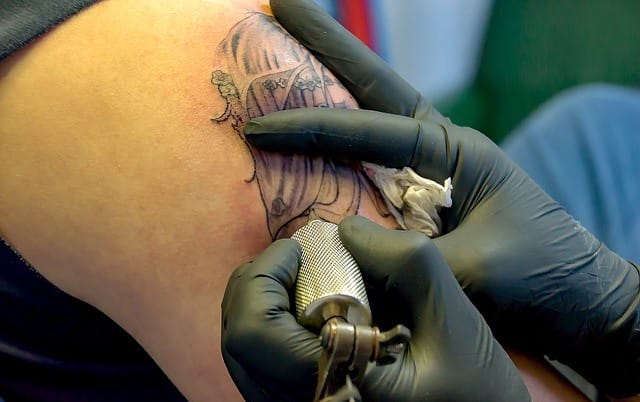 drawing tattoo on arm